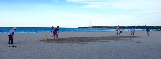 attendees enjoying a game of cricket with the locals