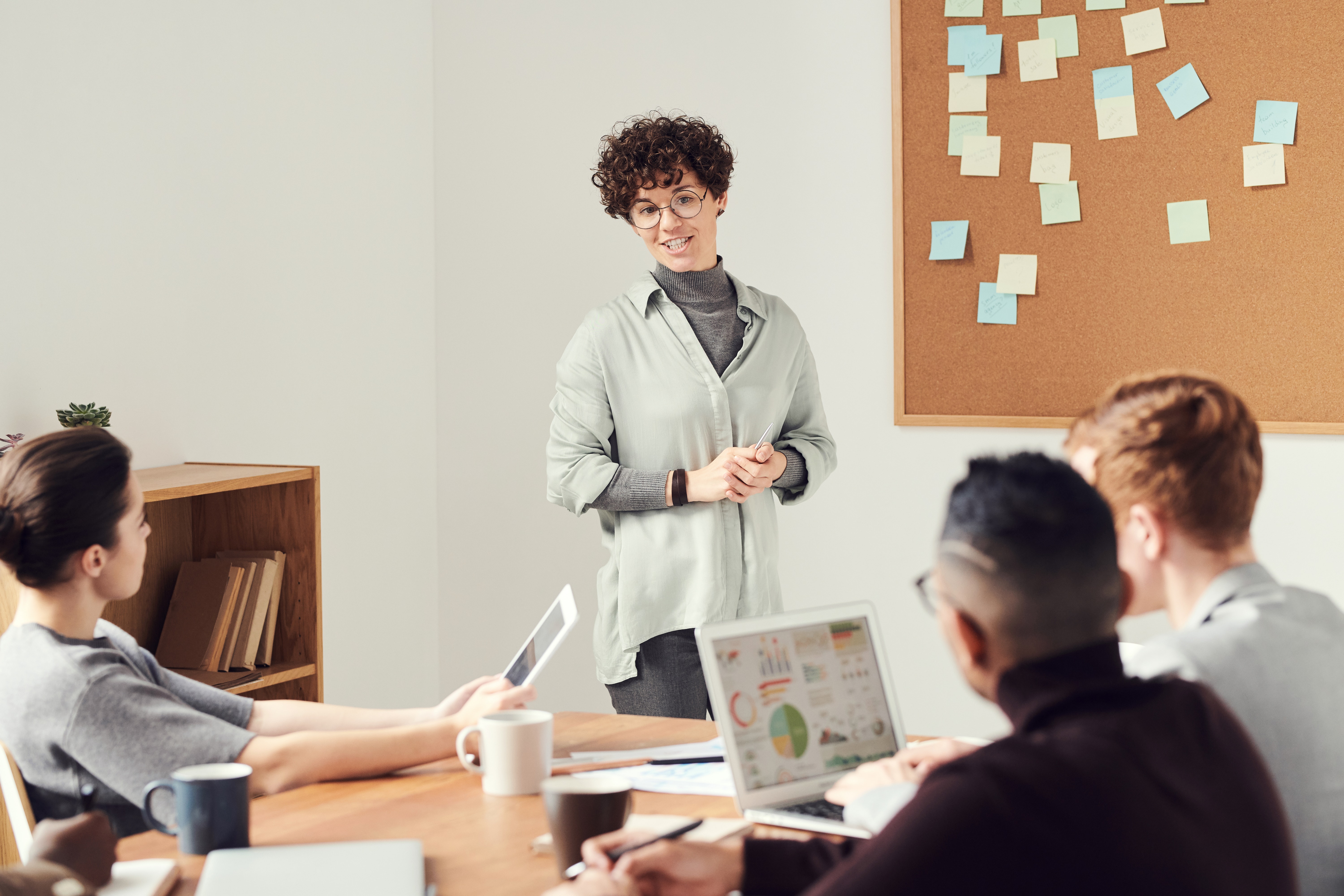 Stock image of woman giving presentation to CEO and team